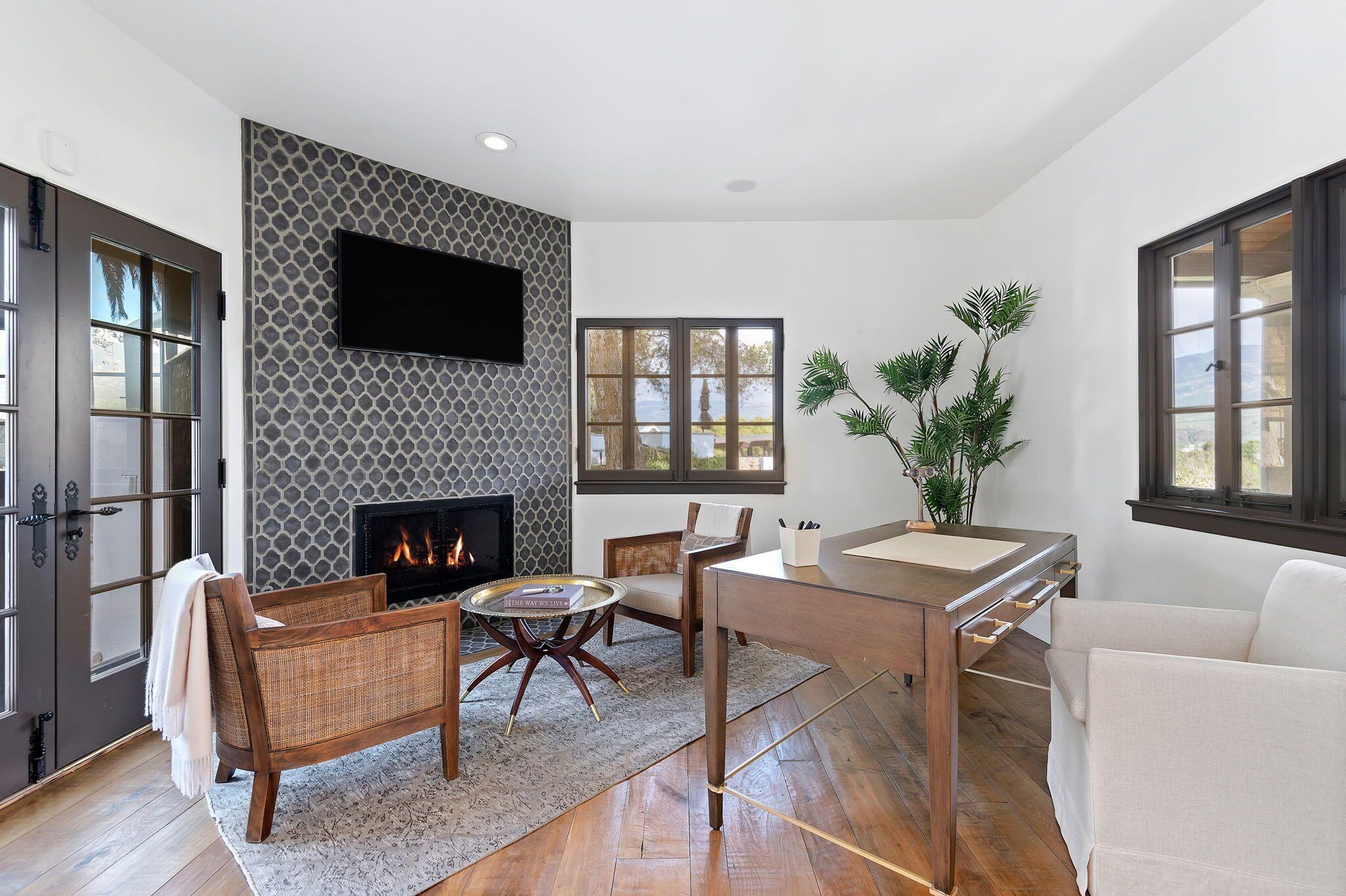 695 Via Hierba Santa Barbara, CA 93110 - Photo 17 of 70 a living room with furniture a flat screen tv and a fireplace