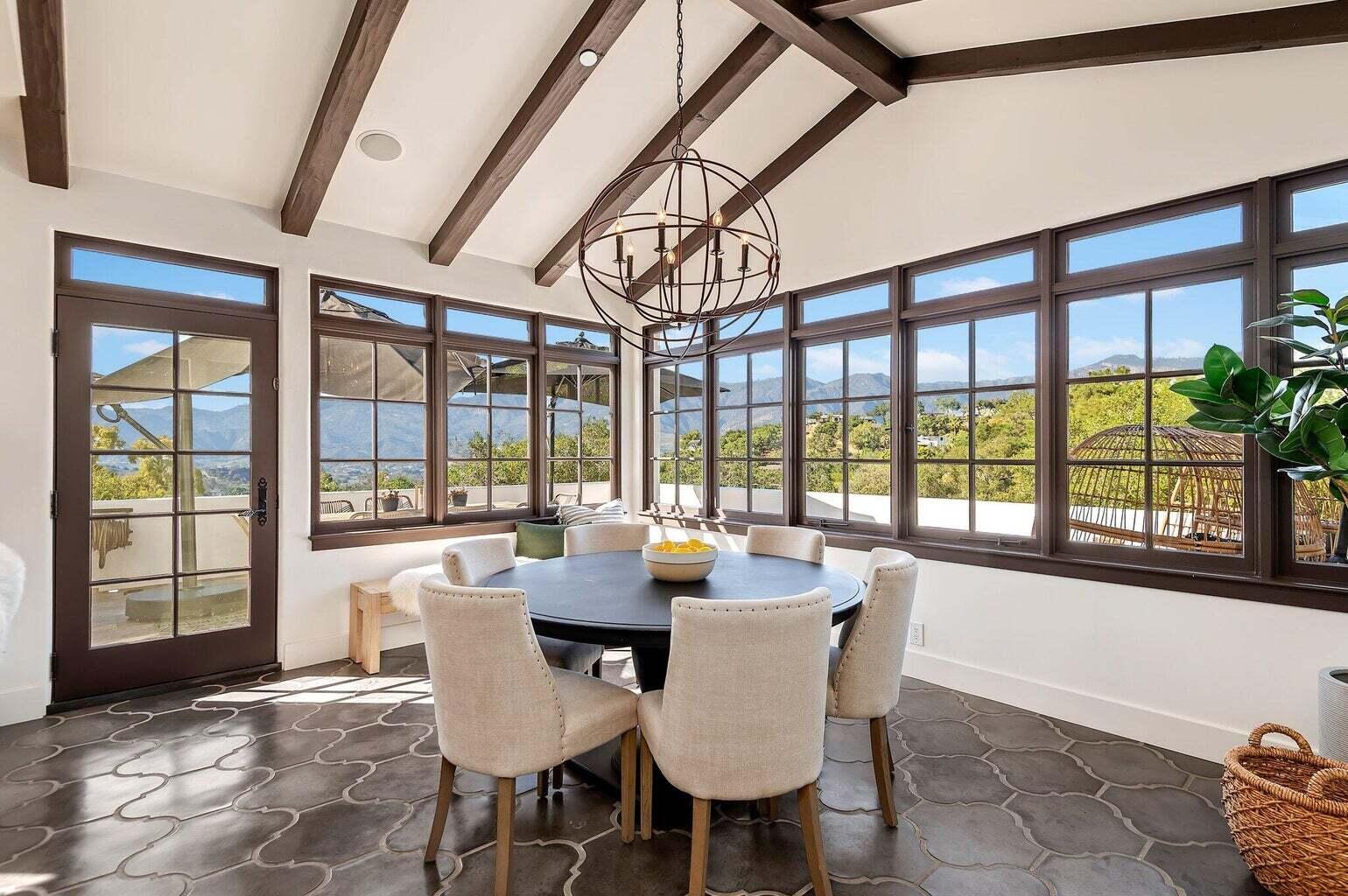 695 Via Hierba Santa Barbara, CA 93110 - Photo 22 of 70 a dining room with furniture a chandelier and wooden floor