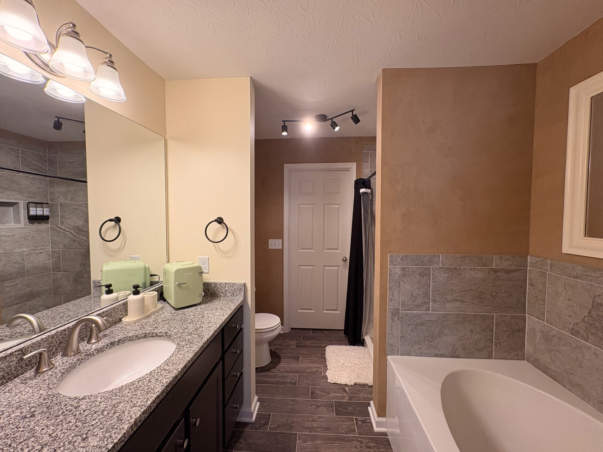 1382 Rural Hill Road, Unit 364 Antioch, TN 37013 - Photo 12 of 22 a bathroom with a granite countertop sink a toilet a mirror and shower