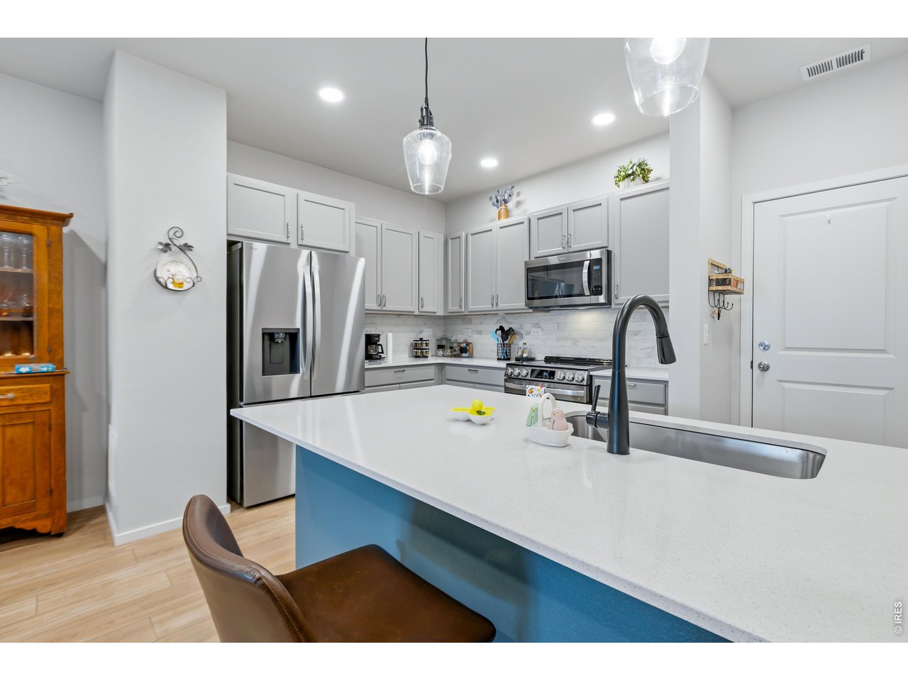 6609 4th St Road, Unit 4 Greeley, CO 80634 - Photo 12 of 41 a kitchen with refrigerator cabinets and wooden floor