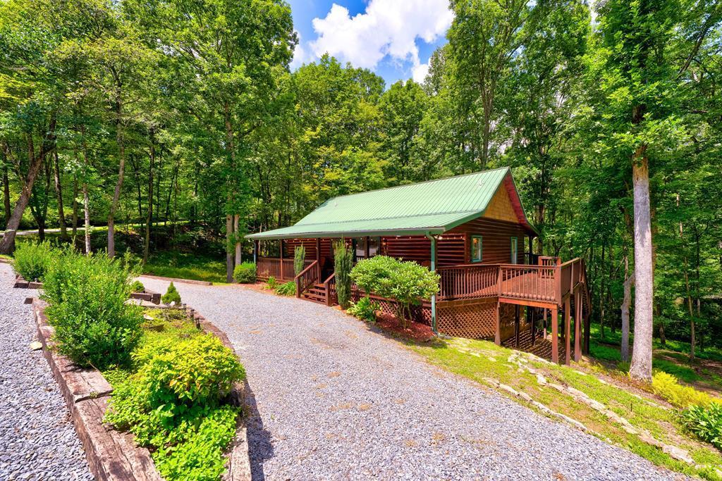 30 The Forest Road Blue Ridge, GA 30513 - Photo 1 of 47 a front view of a house with a yard