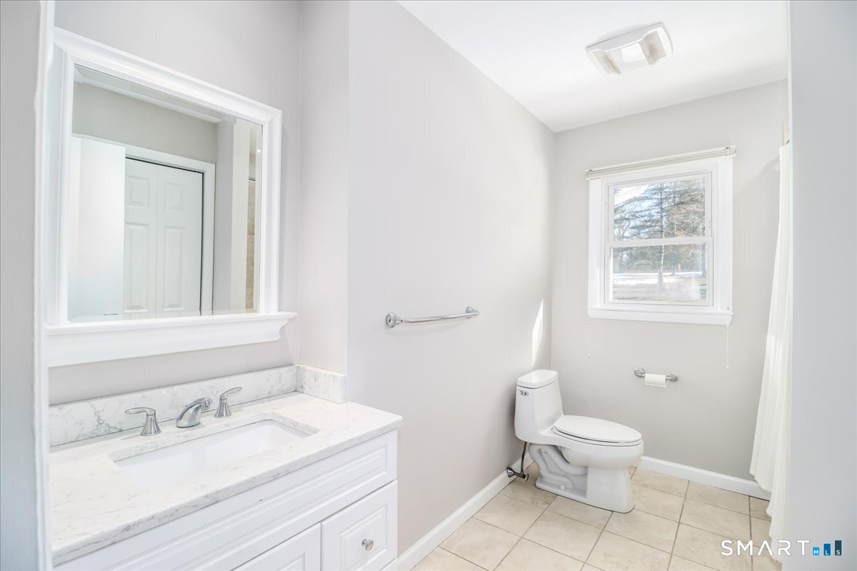 12 South Mountain Road Brookfield, CT 06804 - Photo 12 of 39 a bathroom with a toilet sink vanity and mirror