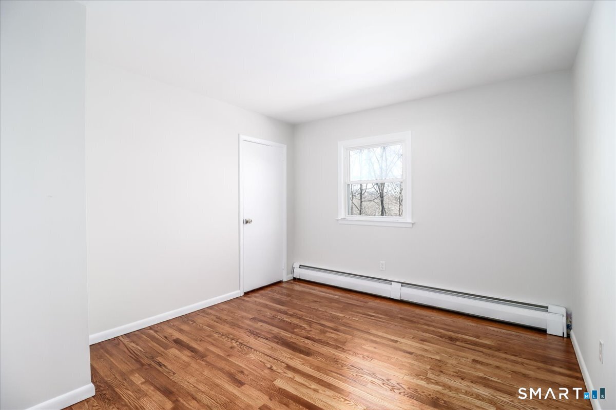 12 South Mountain Road Brookfield, CT 06804 - Photo 13 of 39 an empty room with wooden floor and windows