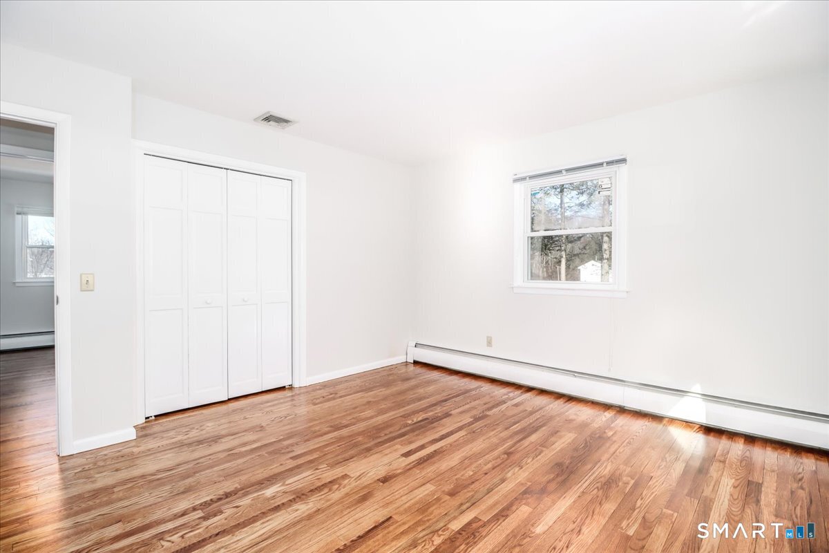 12 South Mountain Road Brookfield, CT 06804 - Photo 15 of 39 an empty room with wooden floor and windows