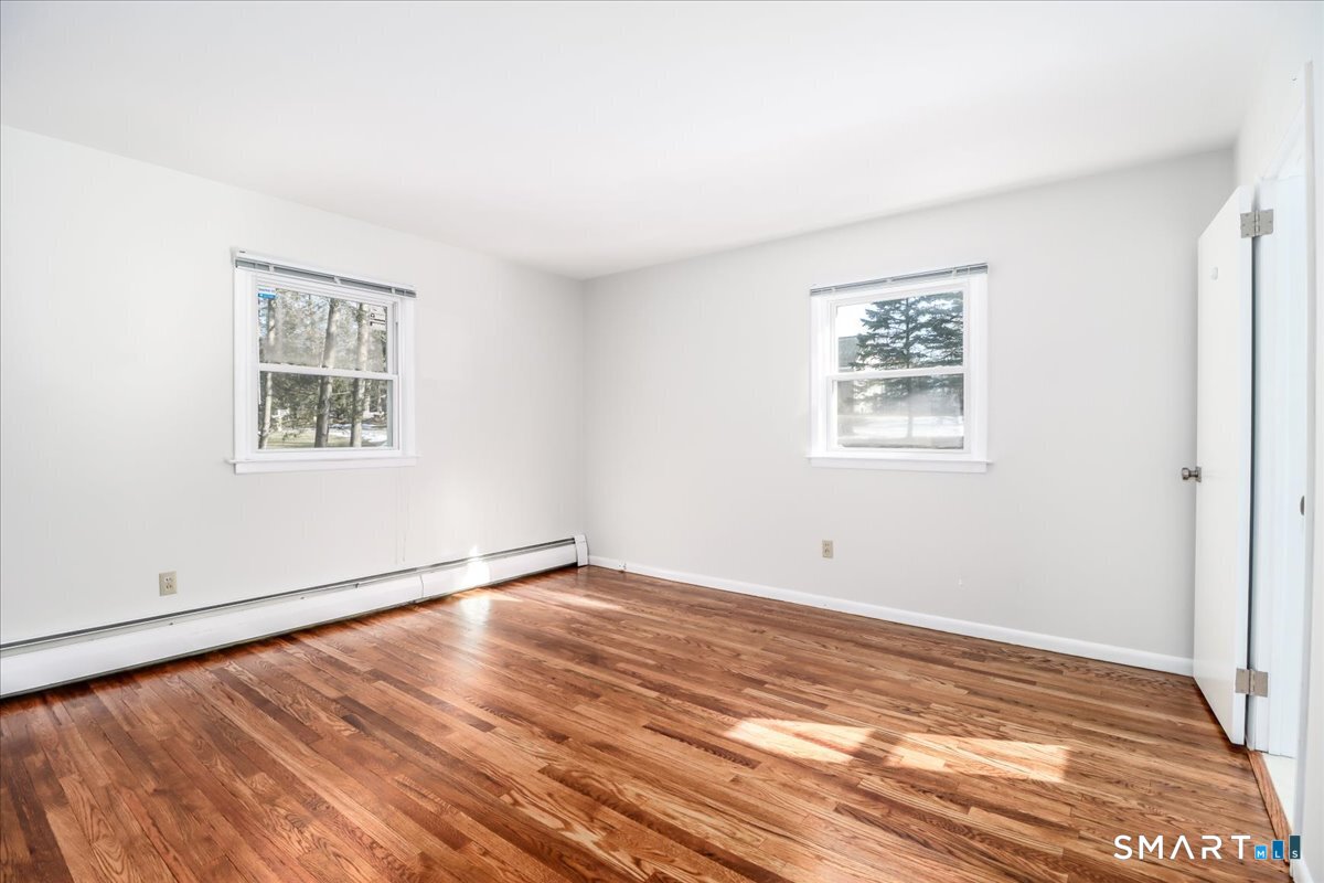 12 South Mountain Road Brookfield, CT 06804 - Photo 17 of 39 a view of an empty room with wooden floor and a window