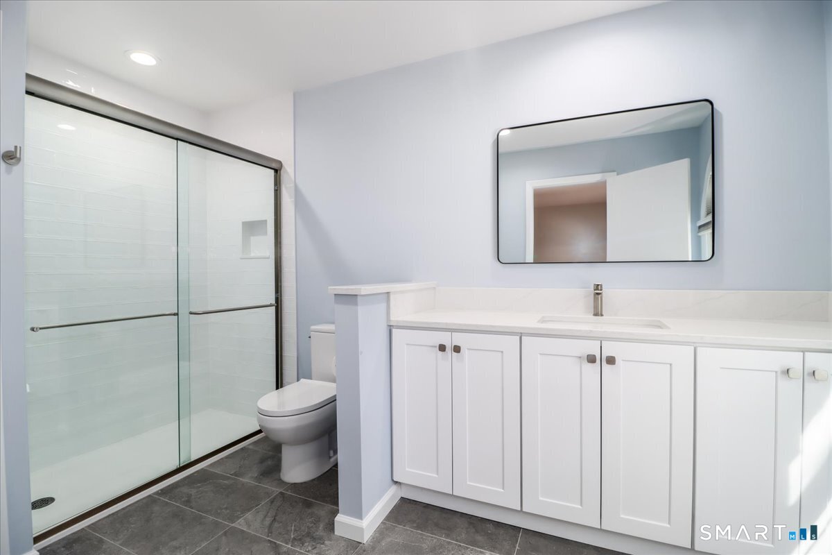 12 South Mountain Road Brookfield, CT 06804 - Photo 23 of 39 a bathroom with a toilet sink and a mirror