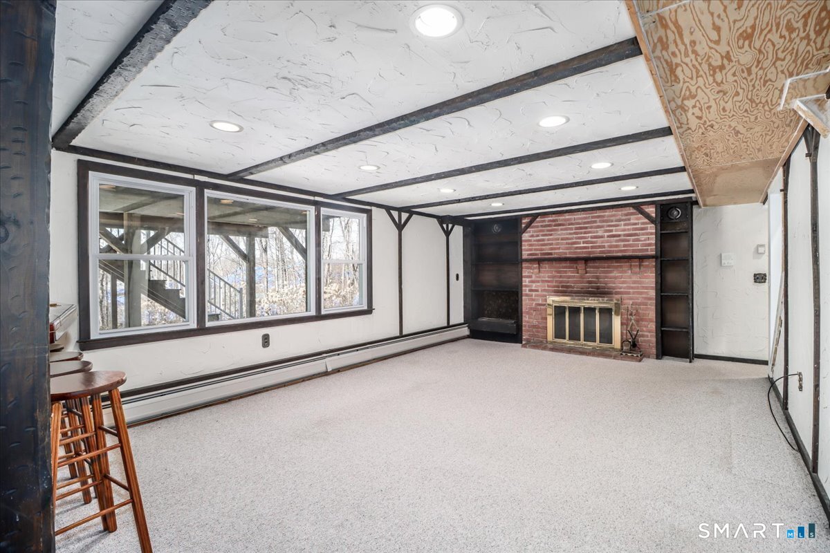 12 South Mountain Road Brookfield, CT 06804 - Photo 26 of 39 a view of an empty room with a fireplace and a window