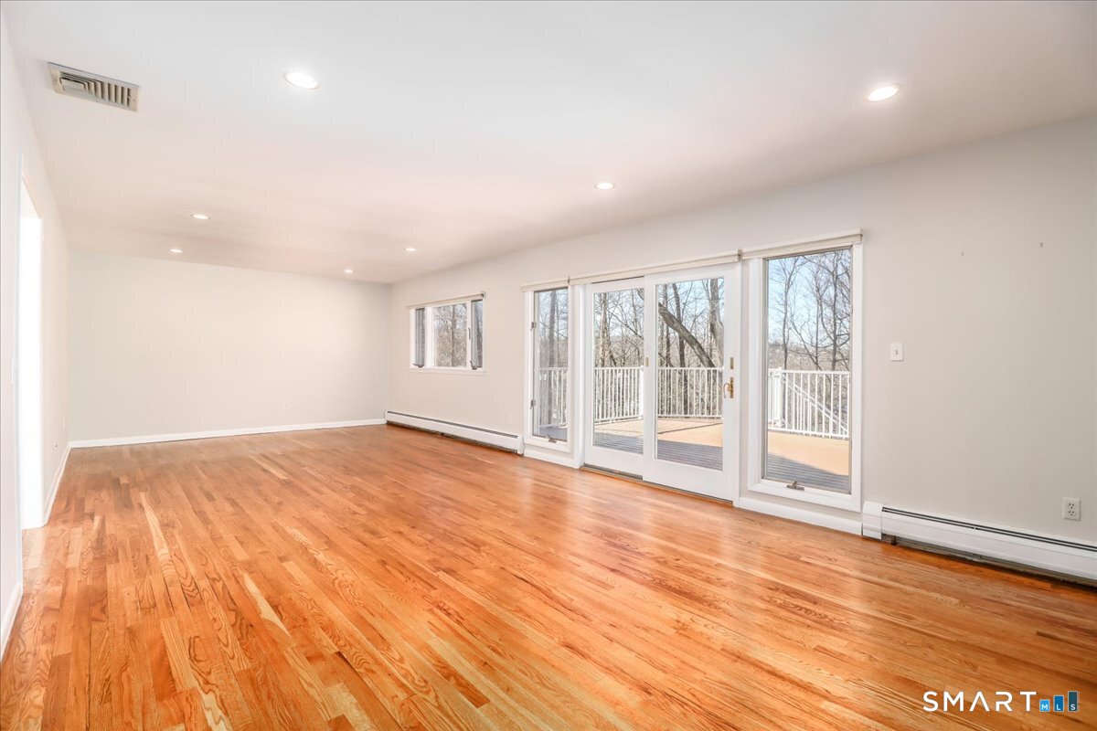 12 South Mountain Road Brookfield, CT 06804 - Photo 10 of 39 wooden floor in an empty room with a window