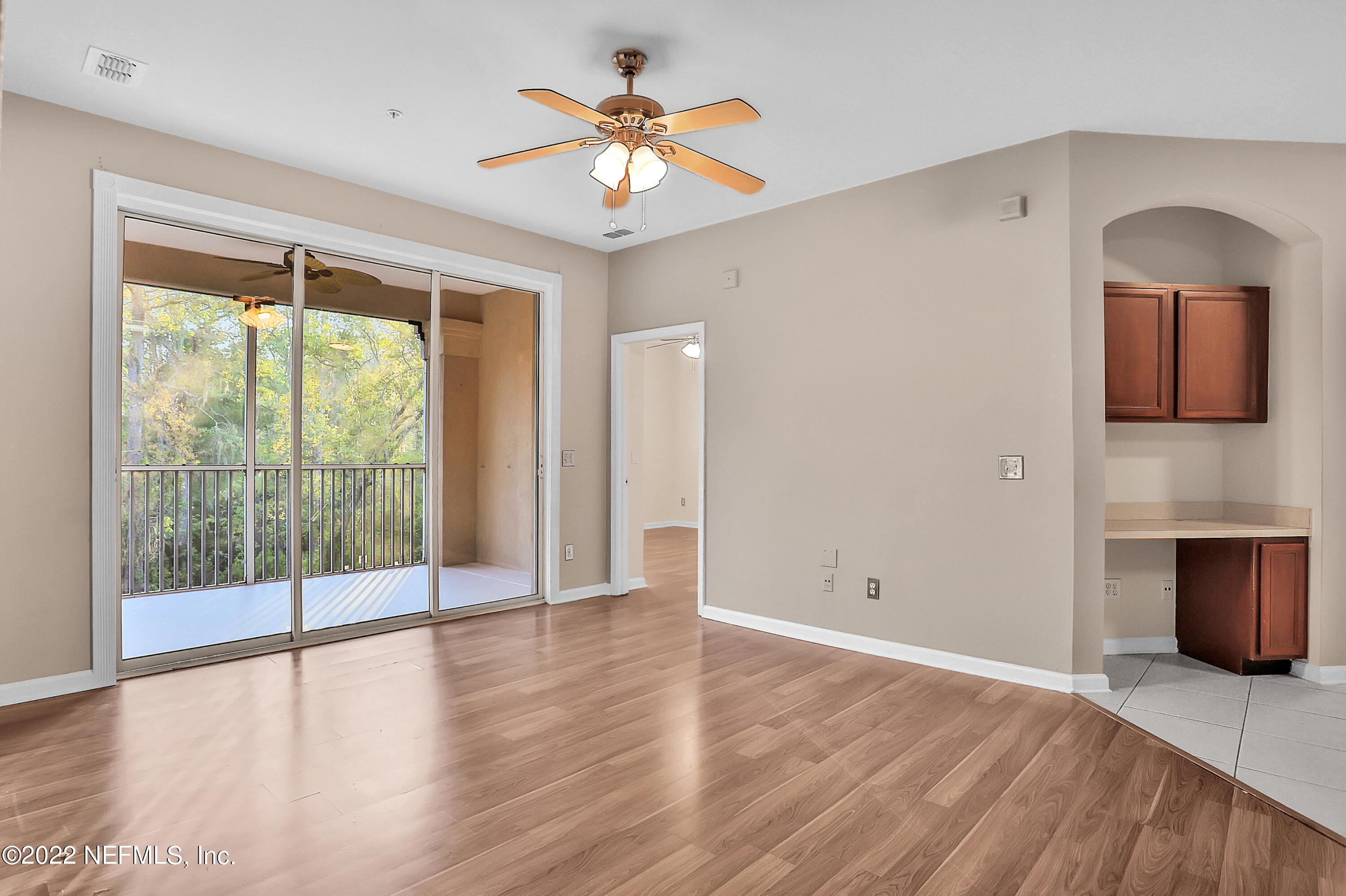 8601 Beach Boulevard, Unit 511 Jacksonville, FL 32216 - Photo 12 of 25 a view of an empty room with window and wooden floor
