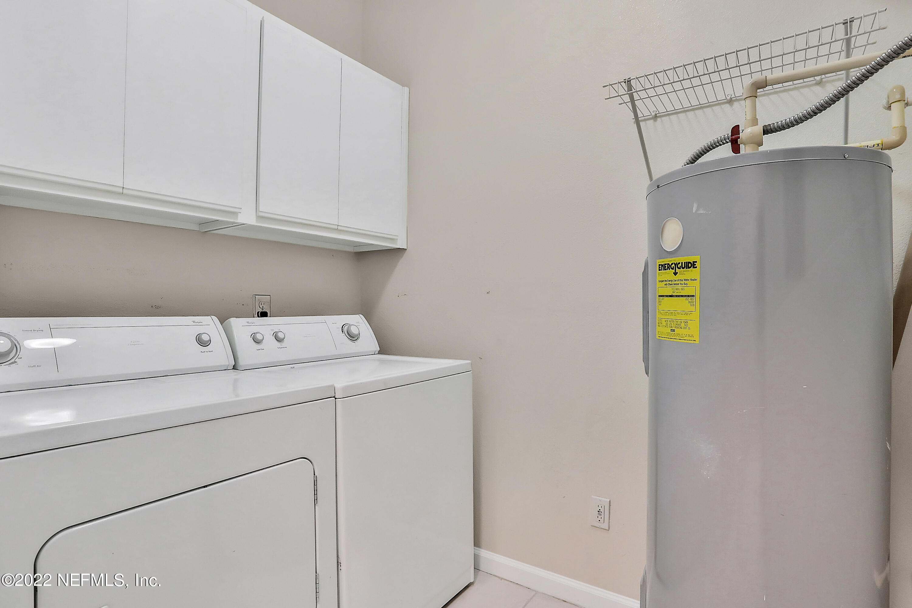 8601 Beach Boulevard, Unit 511 Jacksonville, FL 32216 - Photo 13 of 25 a utility room with dryer and washer