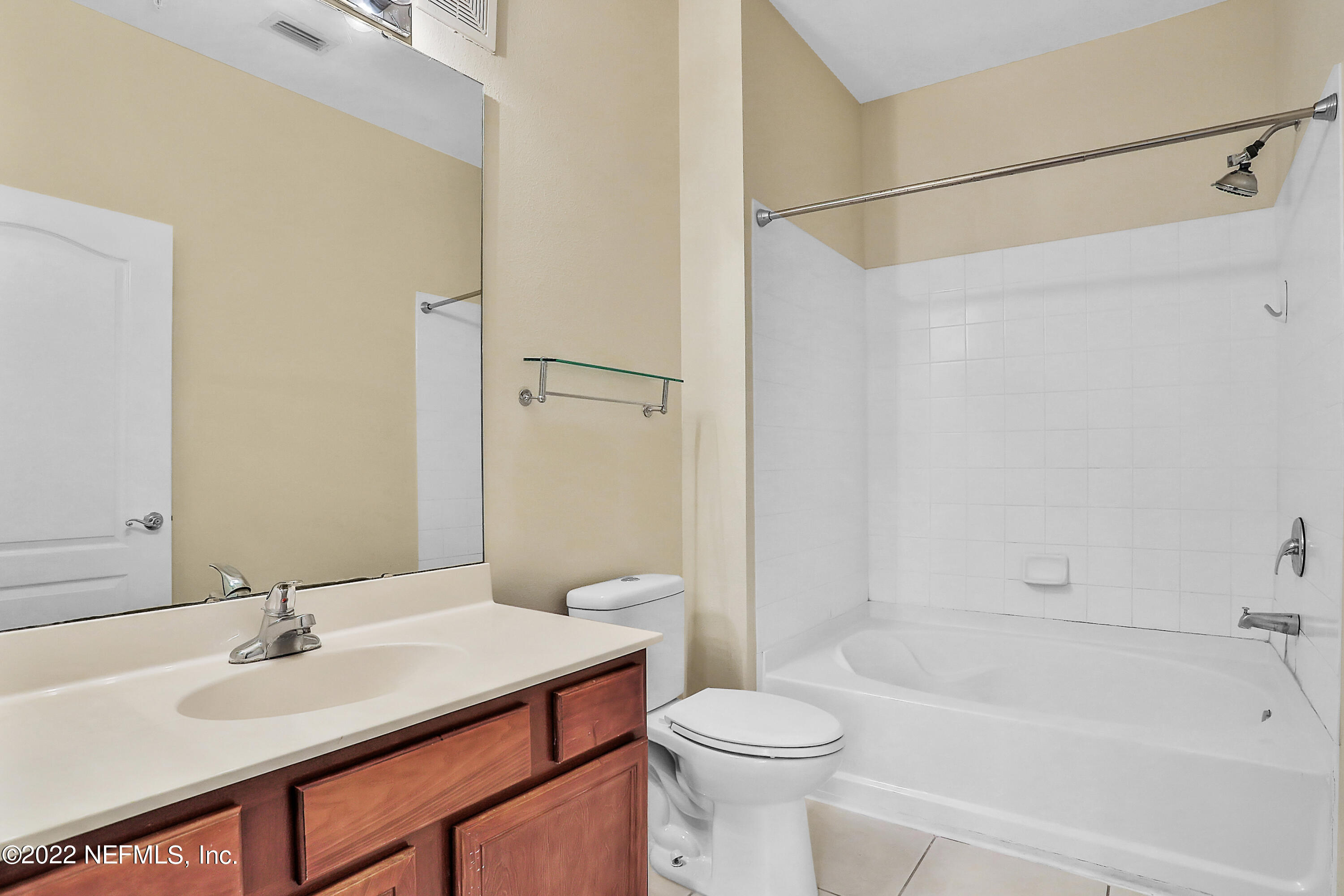 8601 Beach Boulevard, Unit 511 Jacksonville, FL 32216 - Photo 16 of 25 a bathroom with a sink and a mirror