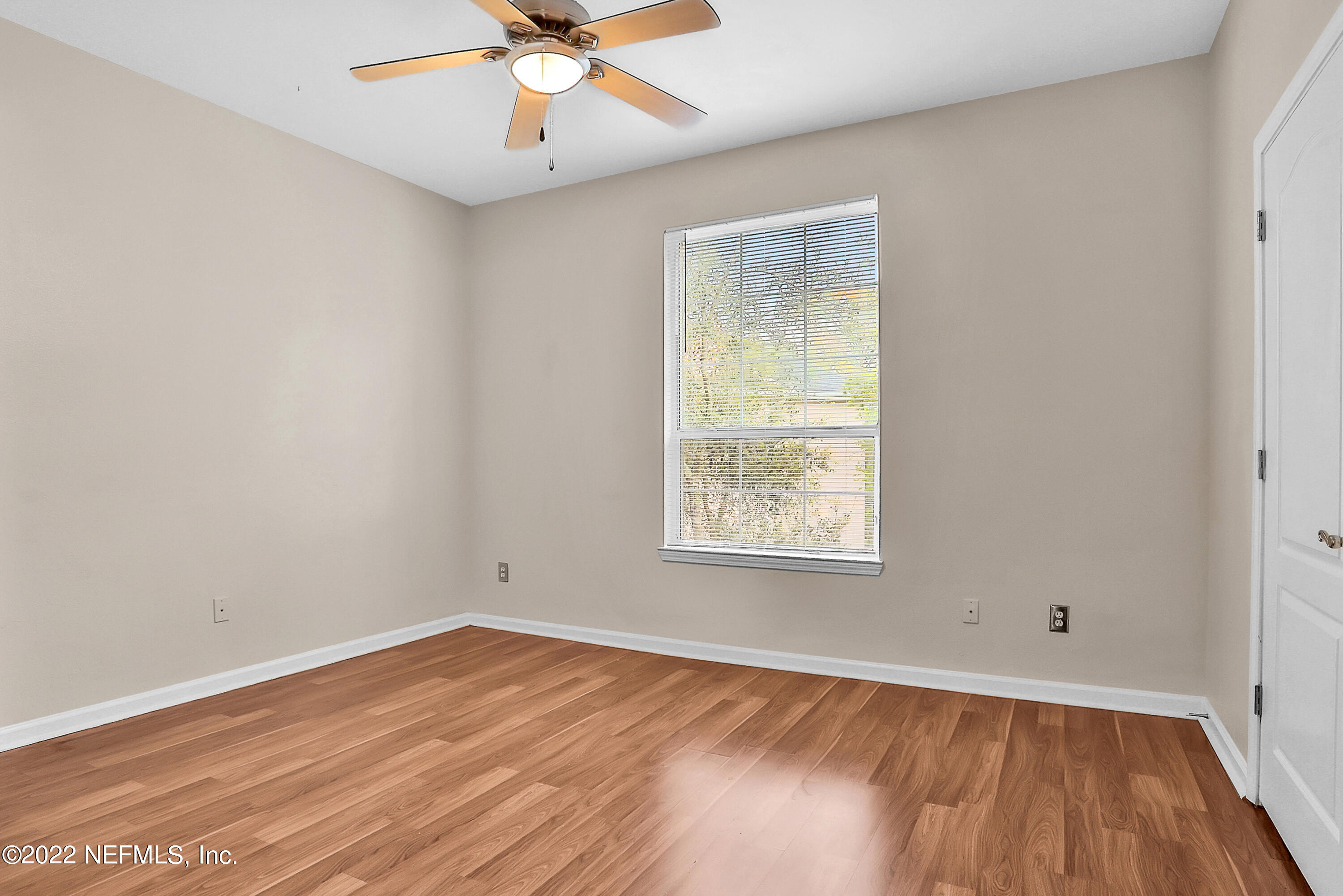 8601 Beach Boulevard, Unit 511 Jacksonville, FL 32216 - Photo 18 of 25 an empty room with a window and wooden floor