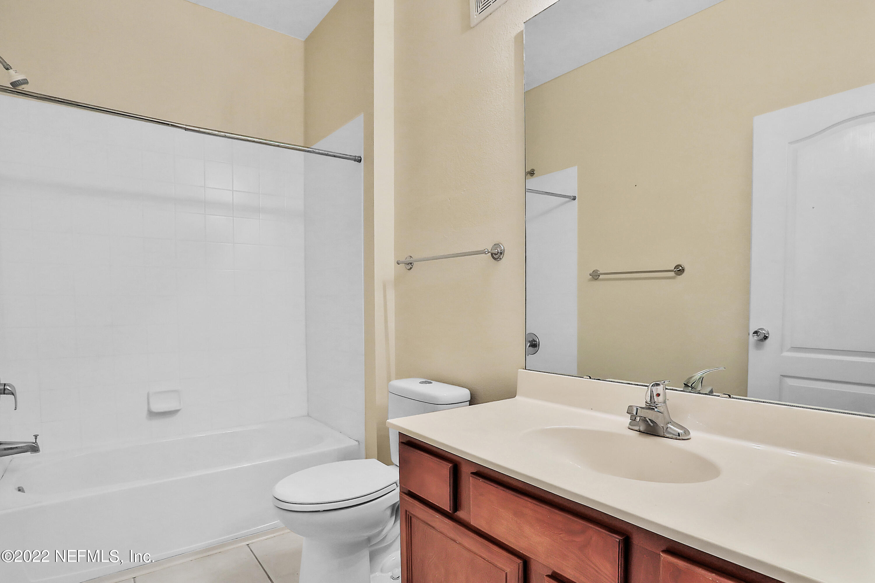 8601 Beach Boulevard, Unit 511 Jacksonville, FL 32216 - Photo 19 of 25 a bathroom with a sink a toilet and shower