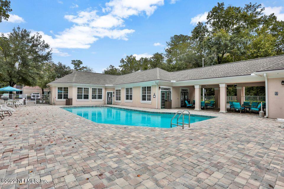 8601 Beach Boulevard, Unit 511 Jacksonville, FL 32216 - Photo 24 of 25 a view of house with swimming pool and porch