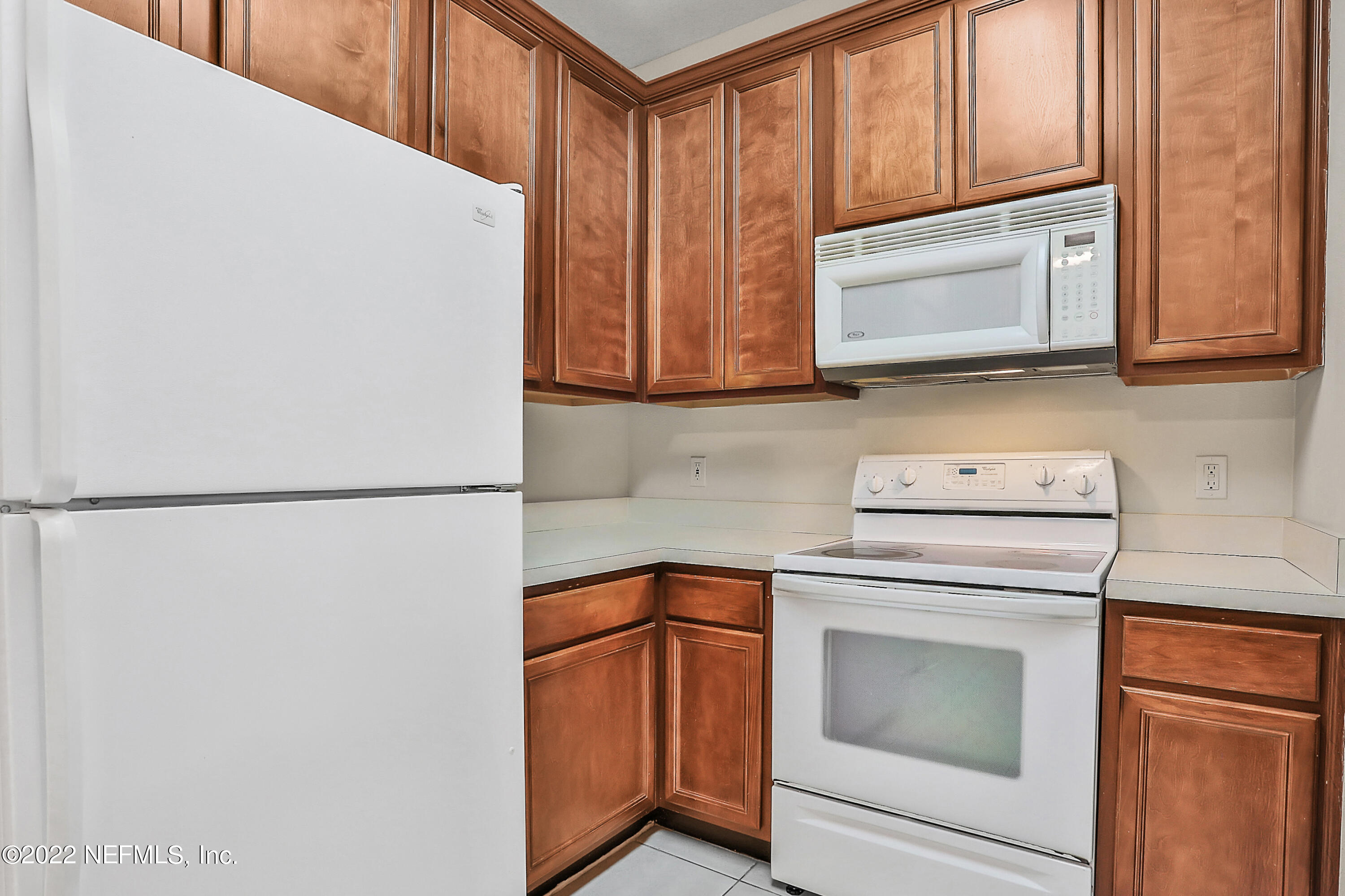 8601 Beach Boulevard, Unit 511 Jacksonville, FL 32216 - Photo 6 of 25 a view of washer and dryer with microwave