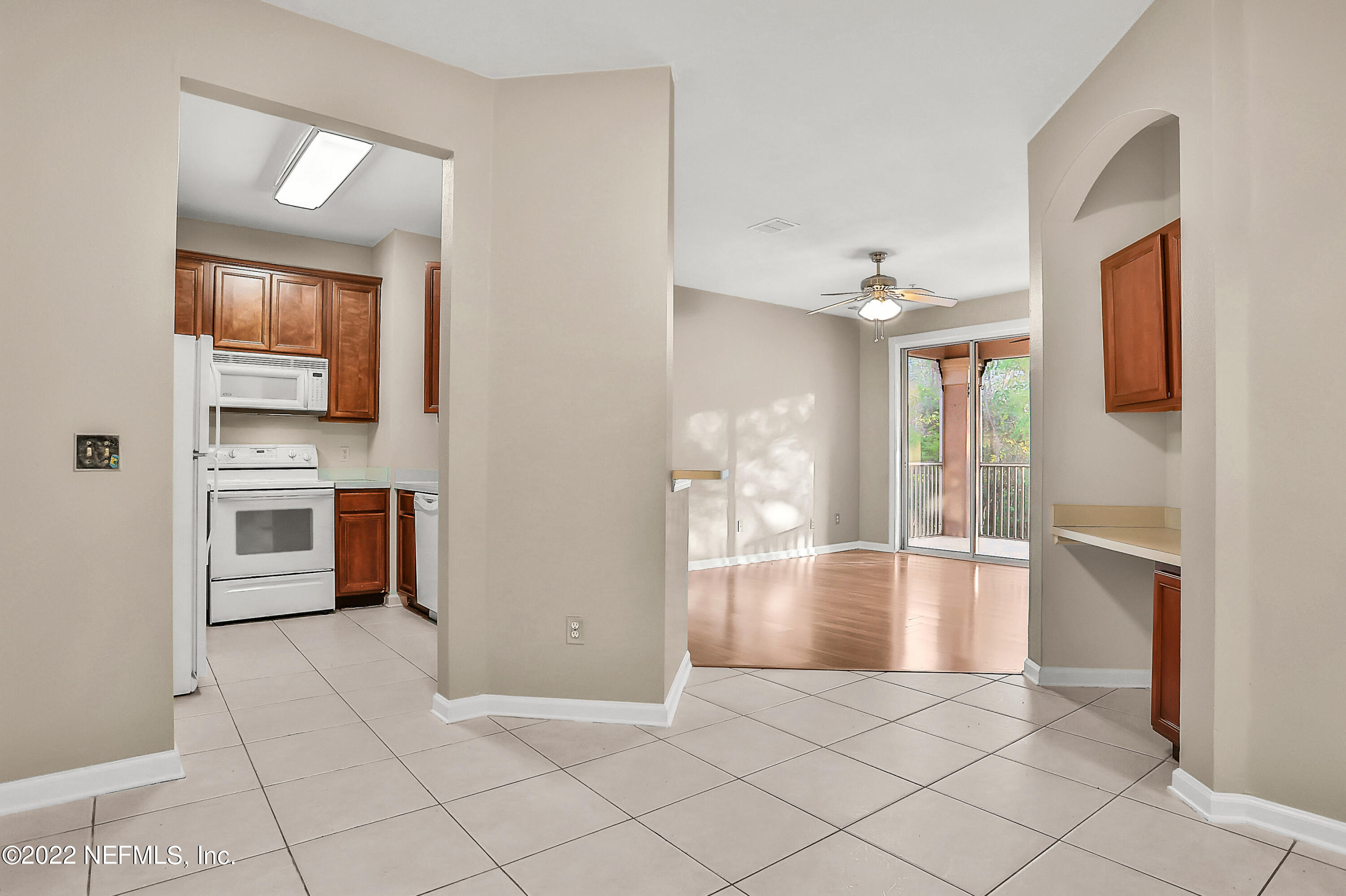 8601 Beach Boulevard, Unit 511 Jacksonville, FL 32216 - Photo 7 of 25 a view of a kitchen with a sink and a living room