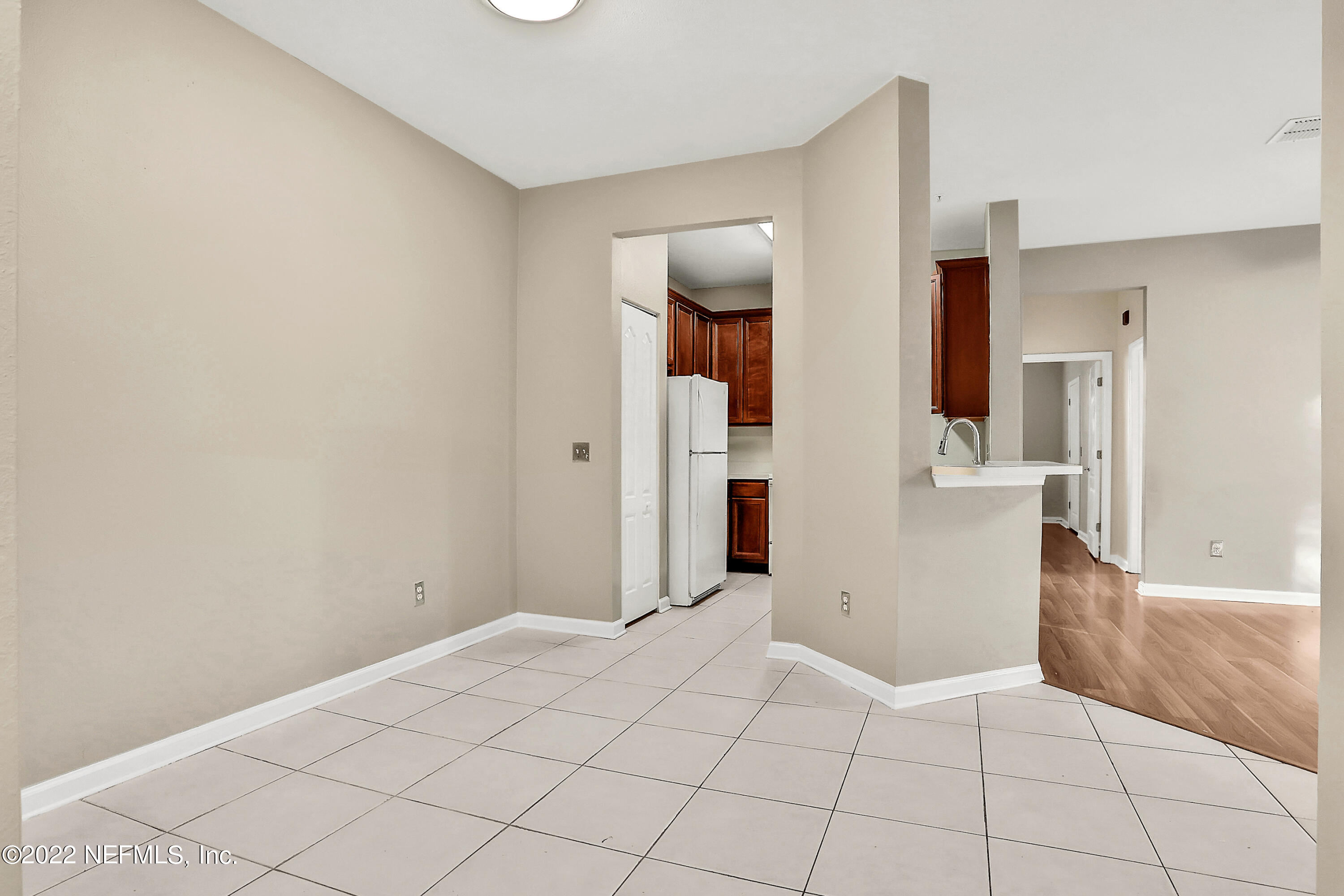 8601 Beach Boulevard, Unit 511 Jacksonville, FL 32216 - Photo 8 of 25 a view of a room with a stylish ceiling fan and entryway