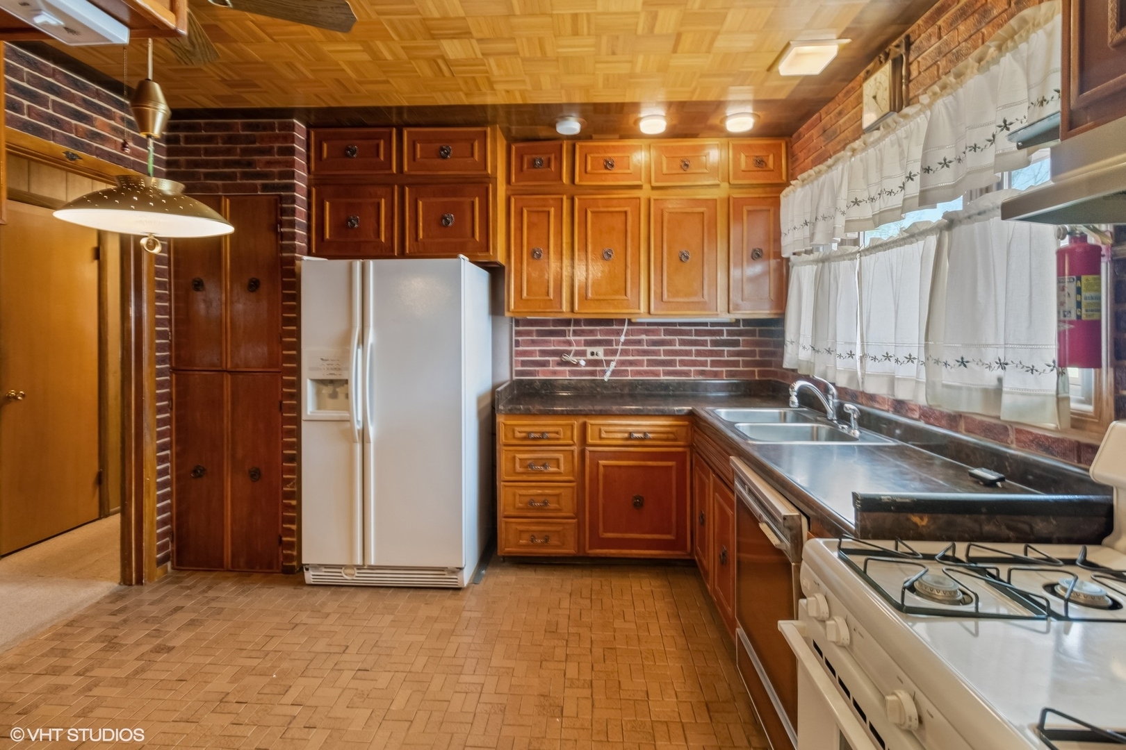 1096 Valley Stream Drive Wheeling, IL 60090 - Photo 7 of 27 a kitchen with stainless steel appliances granite countertop a sink stove and refrigerator