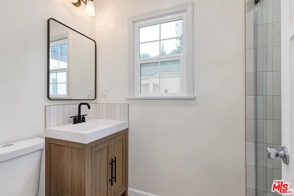 a bathroom with a sink a vanity and a mirror