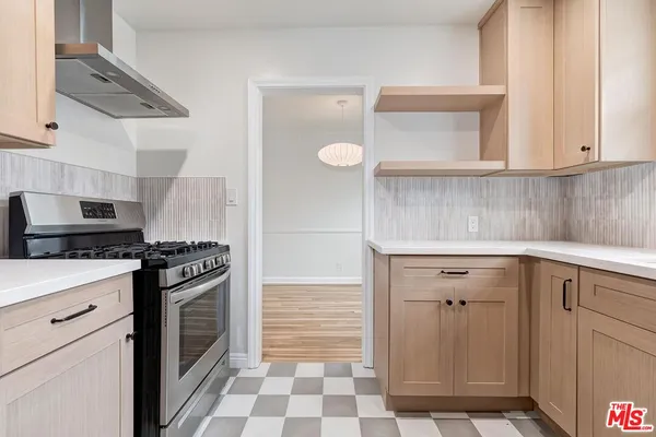 a kitchen with cabinets and appliances