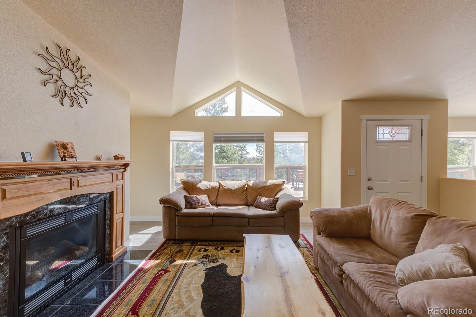 1373 Singletree Road Hartsel, CO 80449 - Photo 9 of 40 a living room with furniture and a fireplace