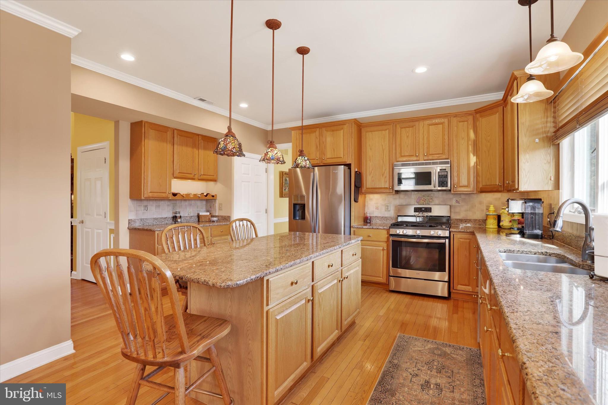 4615 Twinbrook Circle Doylestown, PA 18902 - Photo 9 of 30 a kitchen with stainless steel appliances granite countertop a sink a stove a refrigerator cabinets and chairs