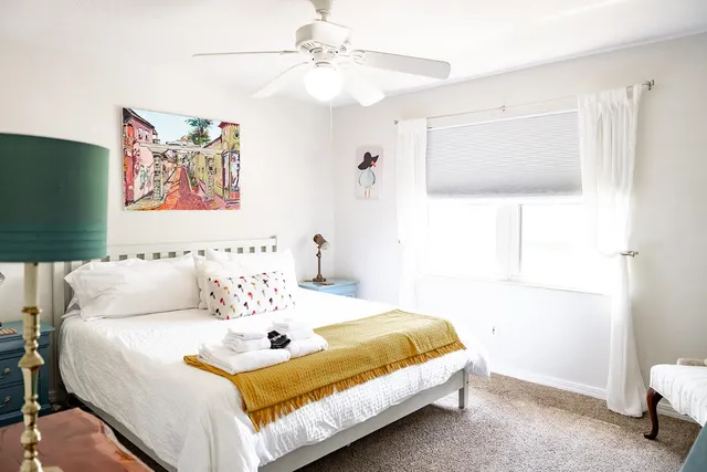 a bedroom with a bed and a chandelier