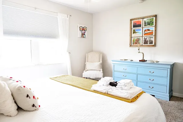 a bedroom with a bed and a dresser