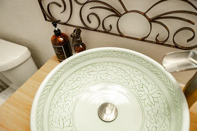 a bathroom with a granite countertop sink and a toilet
