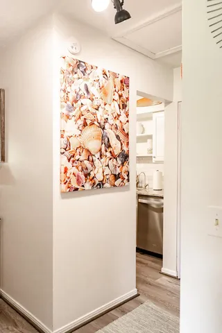 a bed room with a bed and paintings on the wall