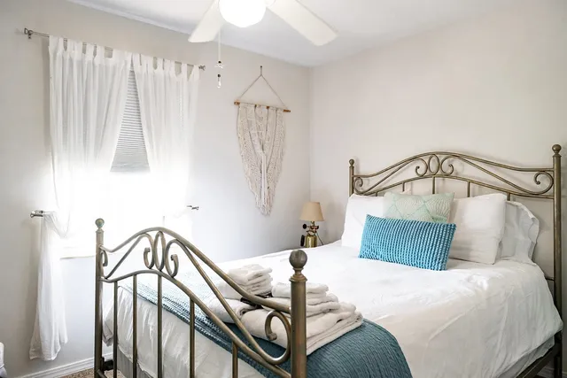 a bedroom with a bed and a mirror