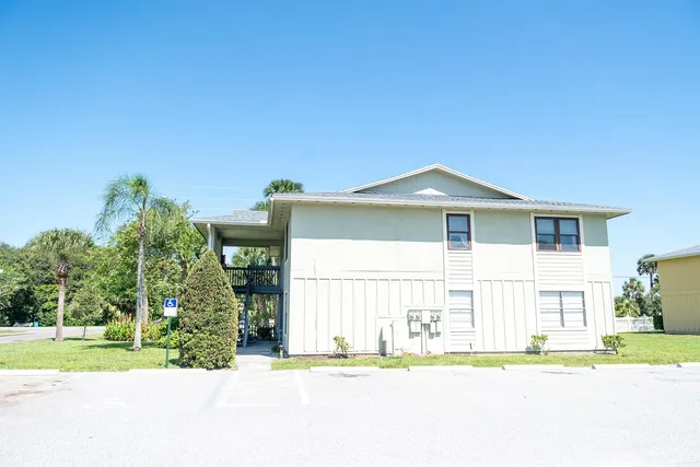 a front view of house with yard and trees