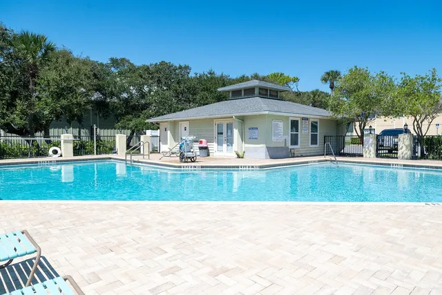 a view of a swimming pool with a lounge chairs