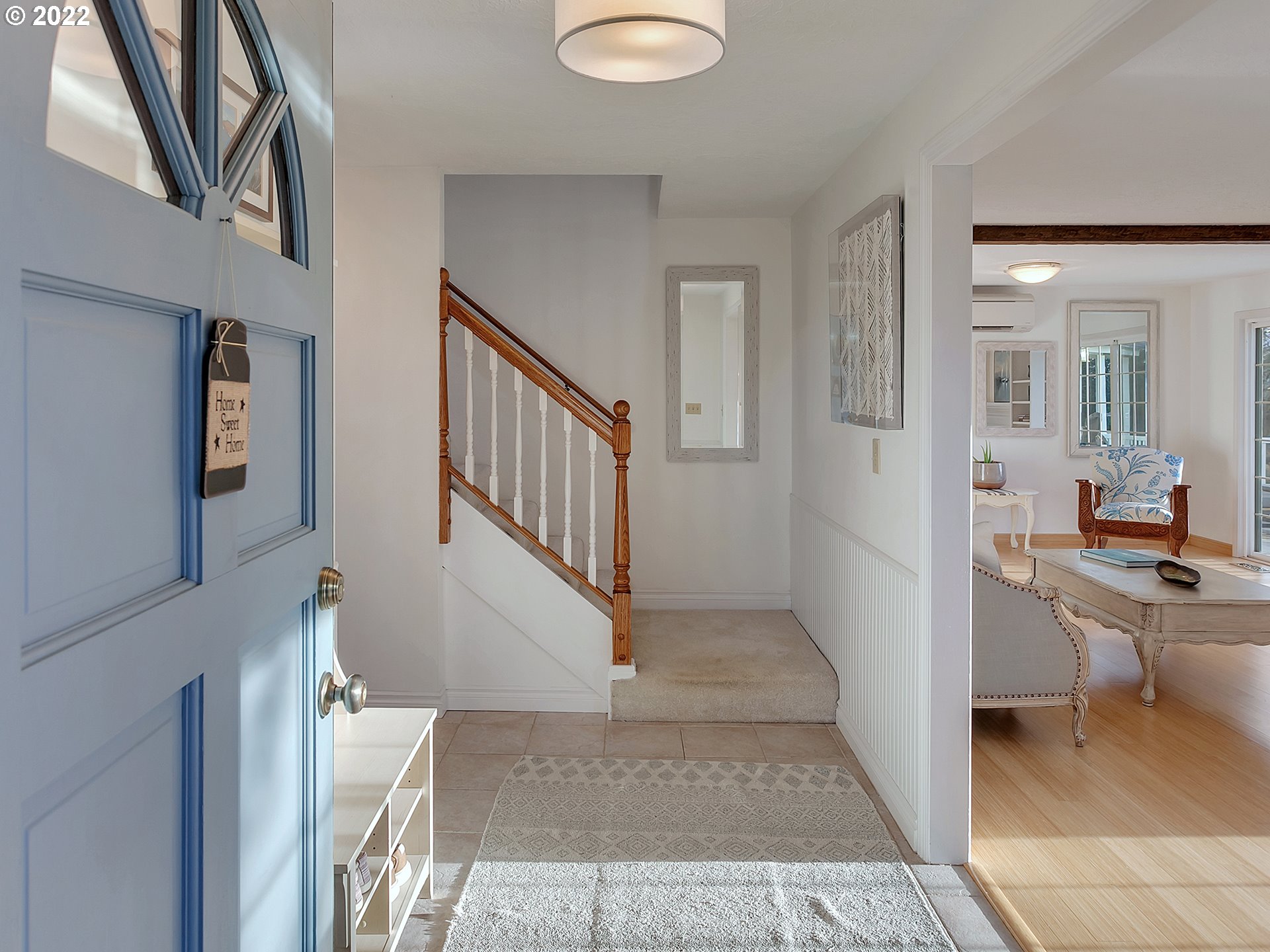 10292 Liberty Road South Salem, OR 97306 - Photo 3 of 32 a view of a hallway to a livingroom with wooden floor and furniture
