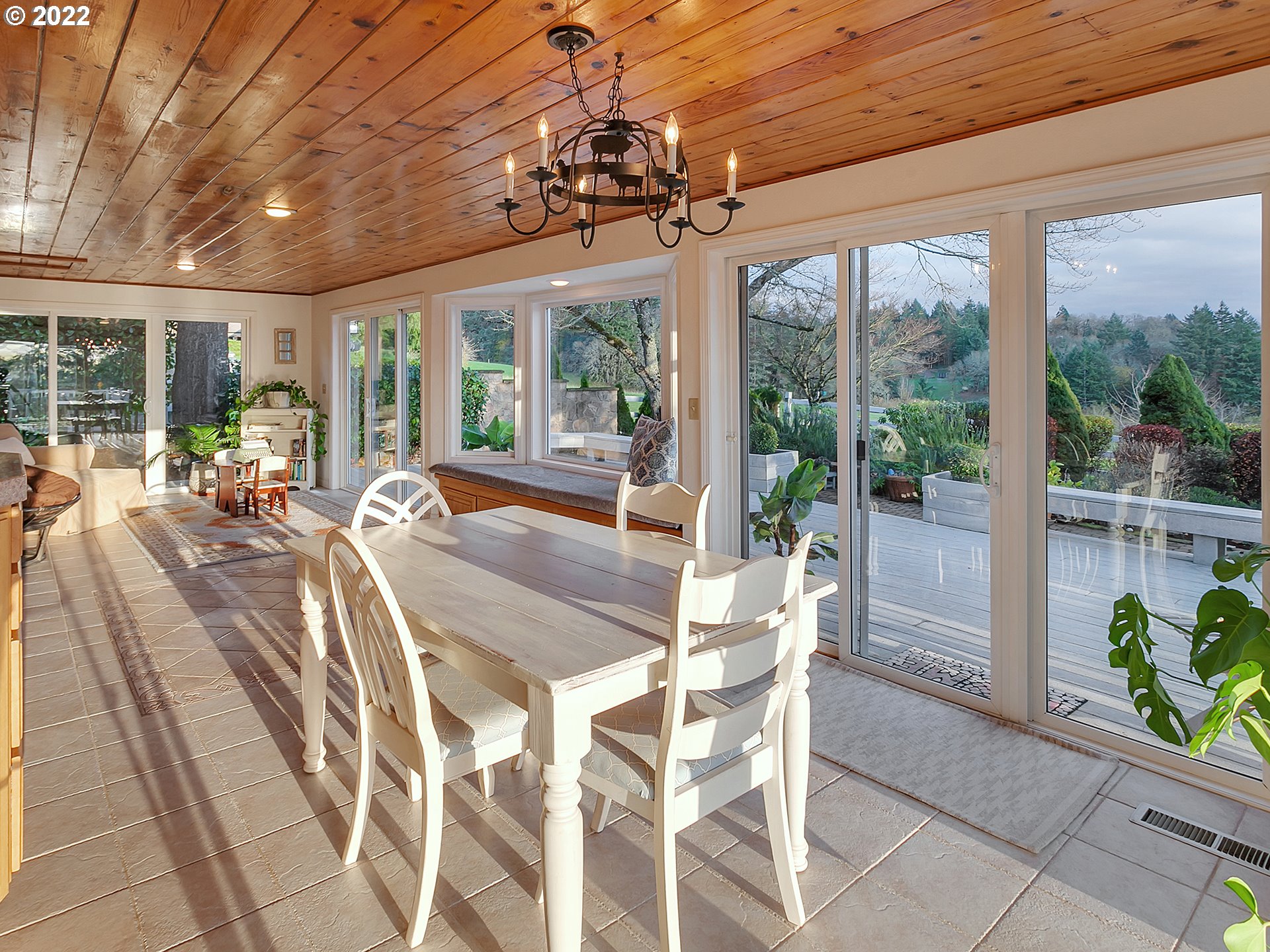 10292 Liberty Road South Salem, OR 97306 - Photo 5 of 32 a view of a dining room with furniture large windows wooden floor and garden view