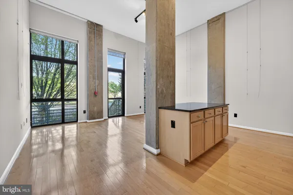 a kitchen with stainless steel appliances granite countertop a refrigerator a stove and a sink
