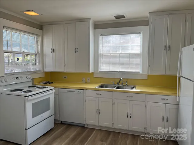 a kitchen with a sink stove and cabinets