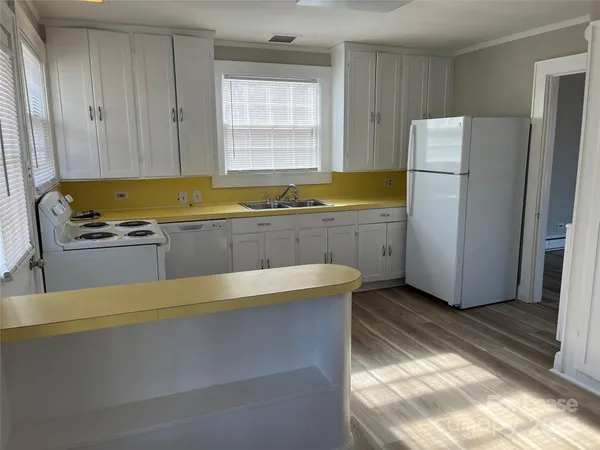 a kitchen with a stove a refrigerator and a sink