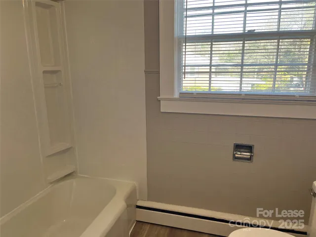 a bathroom with a bathtub and window