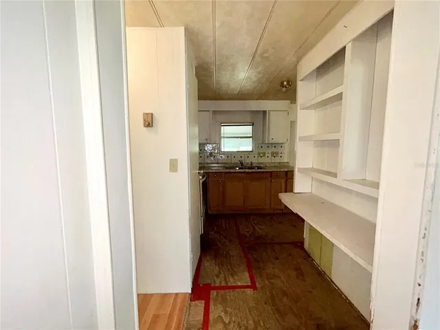 a kitchen with kitchen island granite countertop wooden cabinets and white appliances
