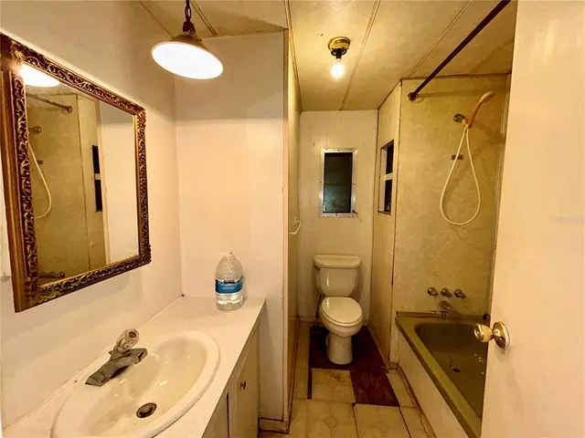 a bathroom with a sink mirror toilet and shower