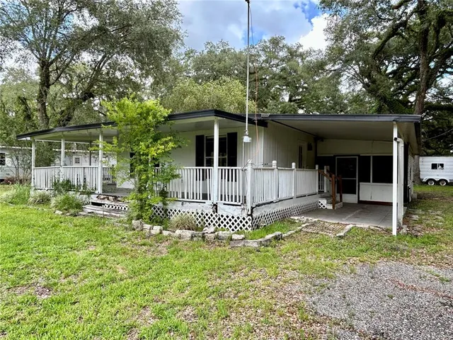 a front view of a house with a yard and porch