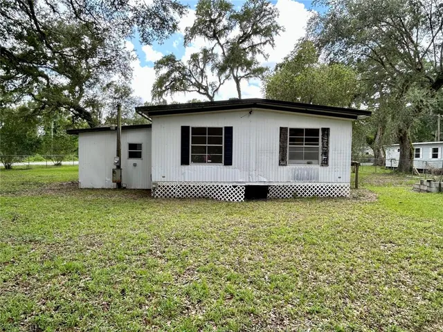 a house with trees in the background