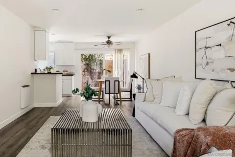 a living room with furniture and a chandelier