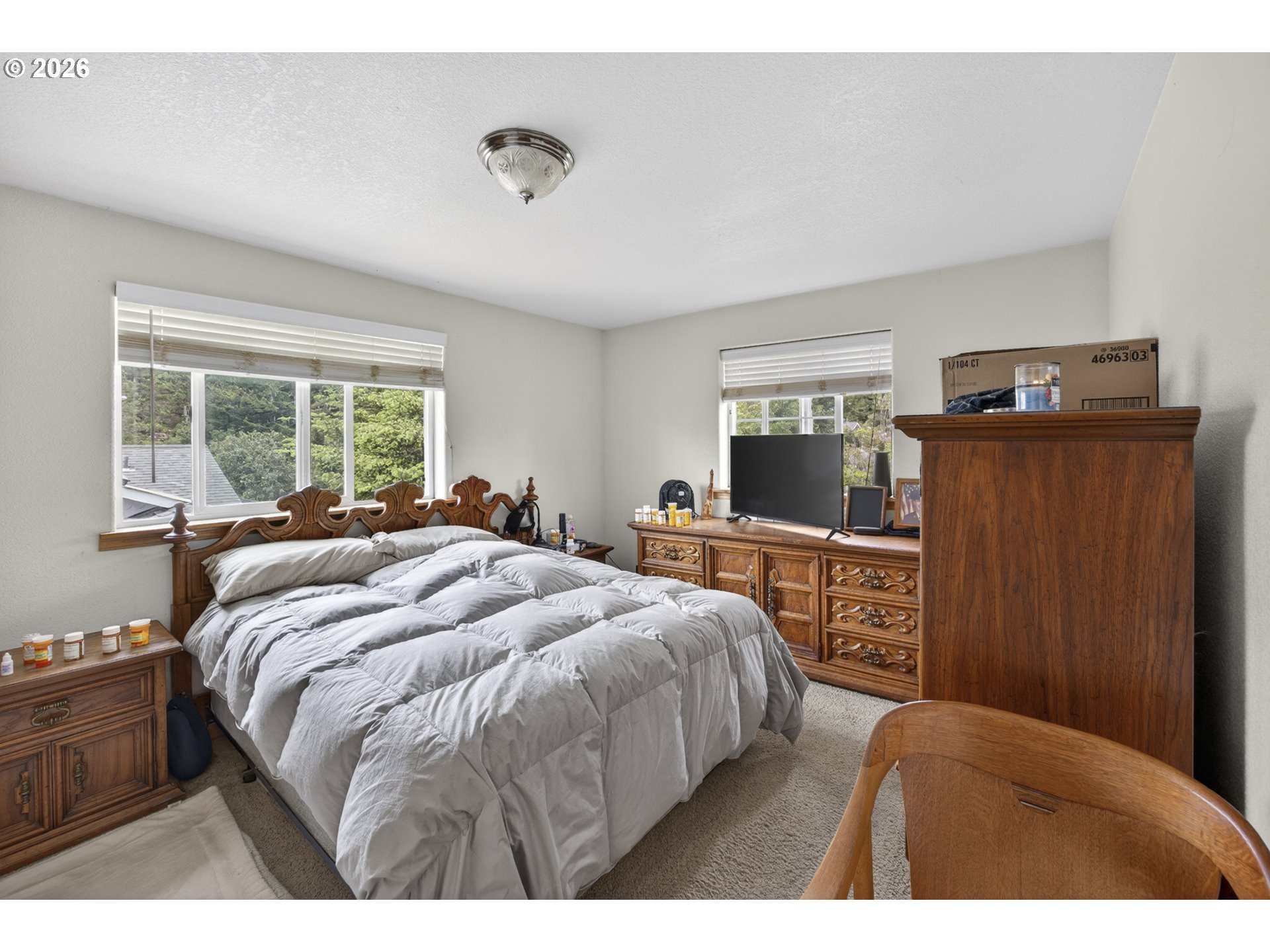 1150 Hemlock Street, Unit B8 Florence, OR 97439 - Photo 11 of 24 a bedroom with a bed and large windows