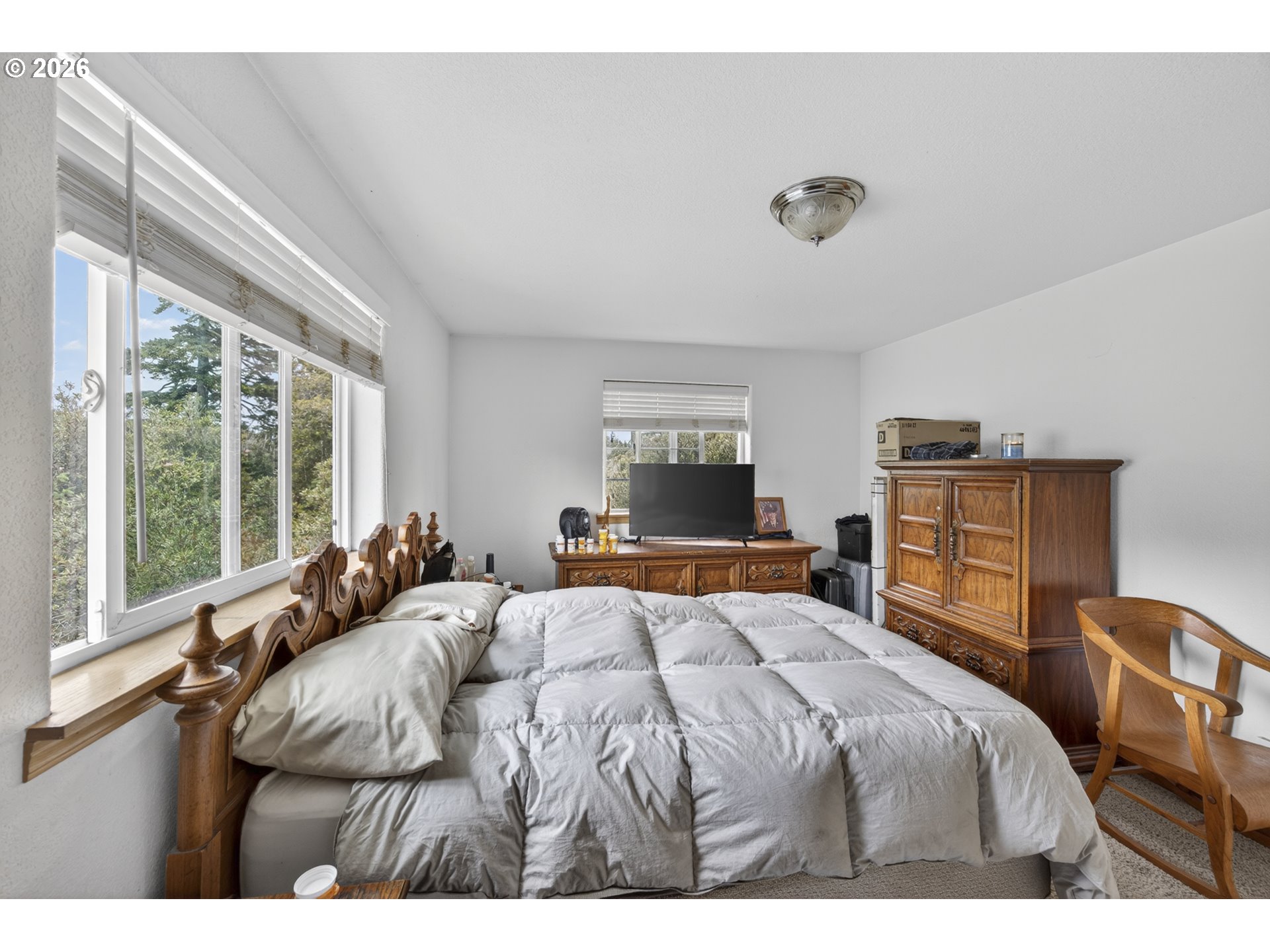 1150 Hemlock Street, Unit B8 Florence, OR 97439 - Photo 12 of 24 a bedroom with a bed and wooden floor