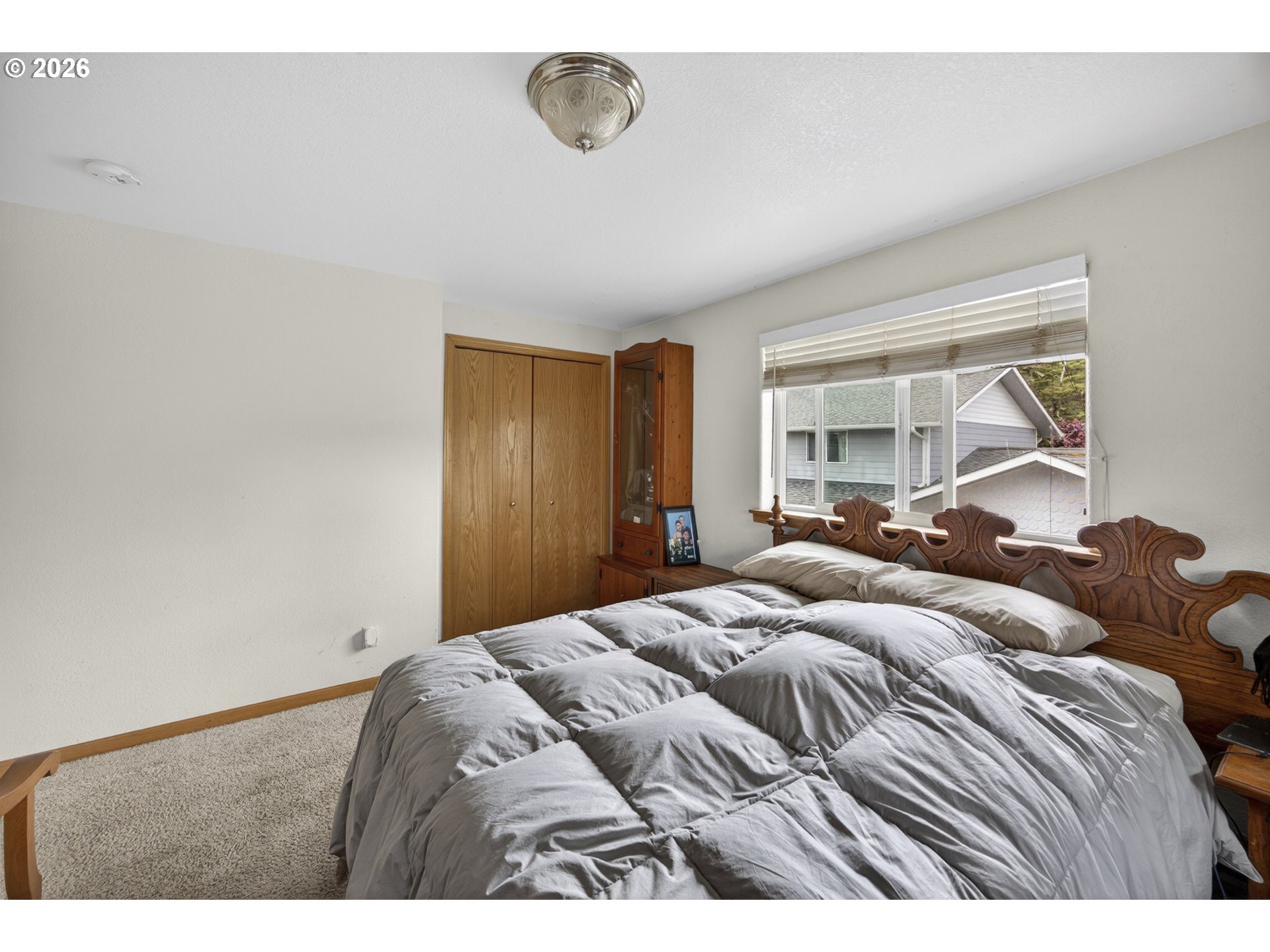 1150 Hemlock Street, Unit B8 Florence, OR 97439 - Photo 13 of 24 a bedroom with a bed and a large mirror
