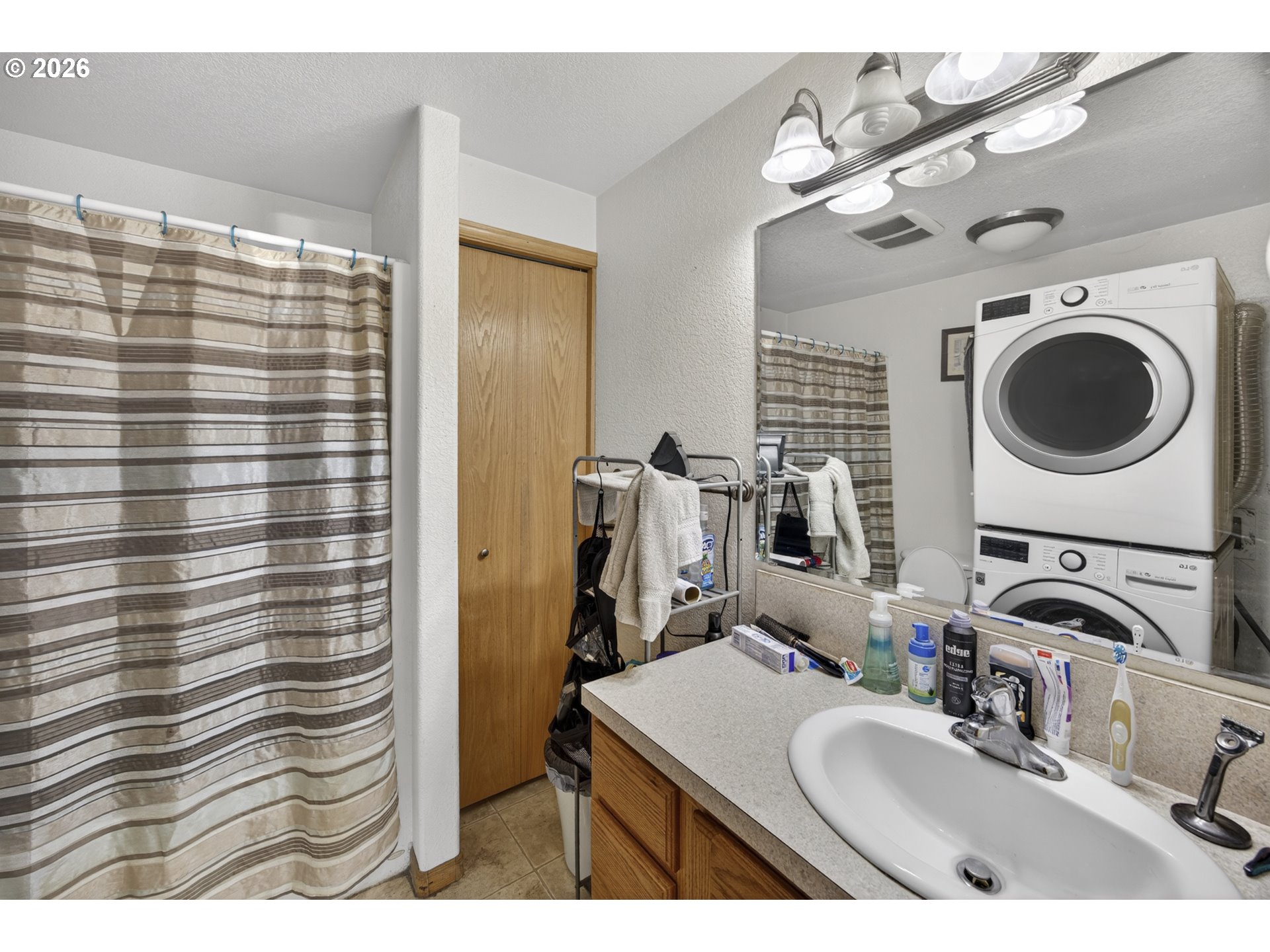 1150 Hemlock Street, Unit B8 Florence, OR 97439 - Photo 16 of 24 a bathroom with a sink a mirror and shower