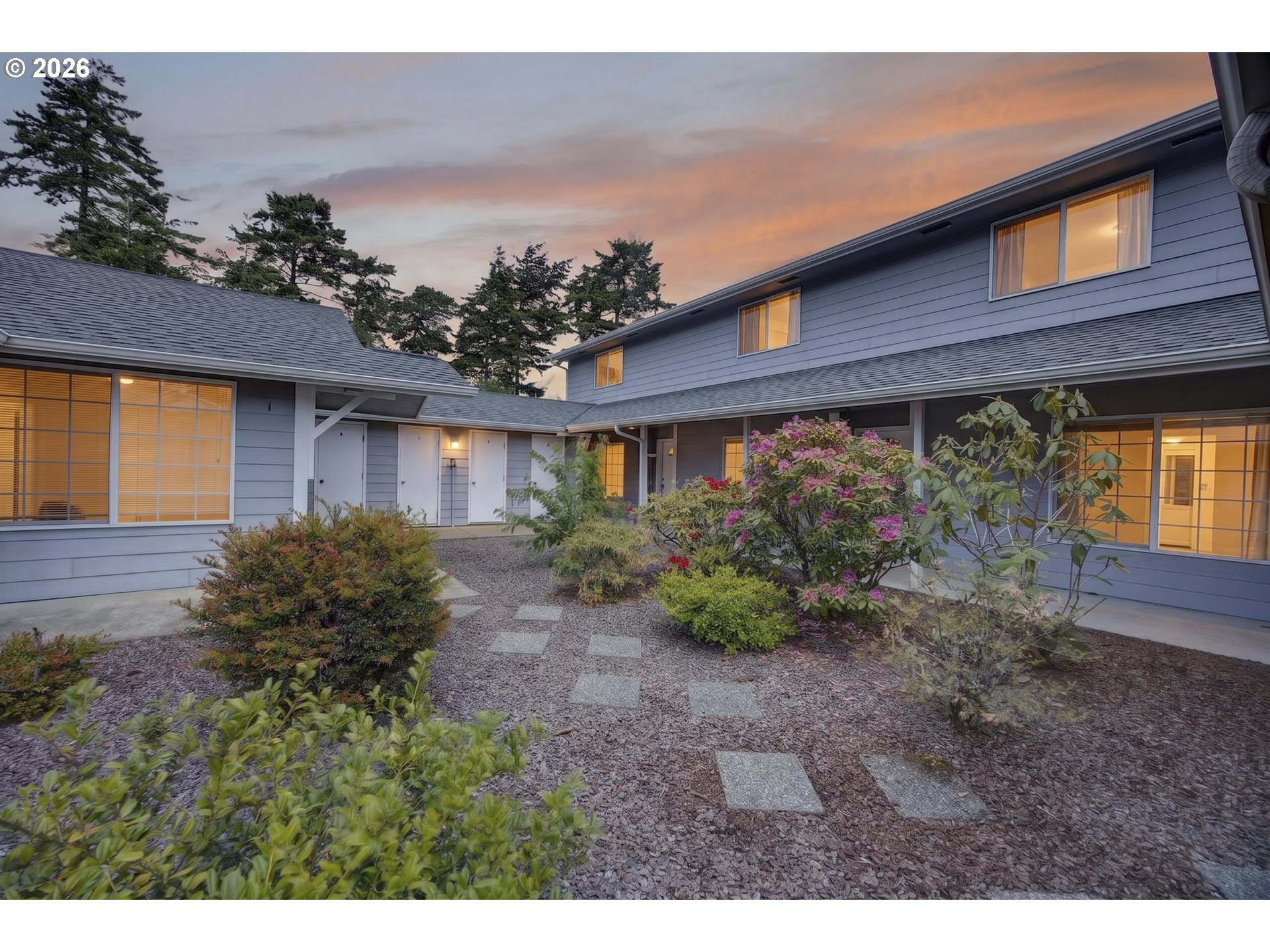 1150 Hemlock Street, Unit B8 Florence, OR 97439 - Photo 2 of 24 a view of a house with a garden