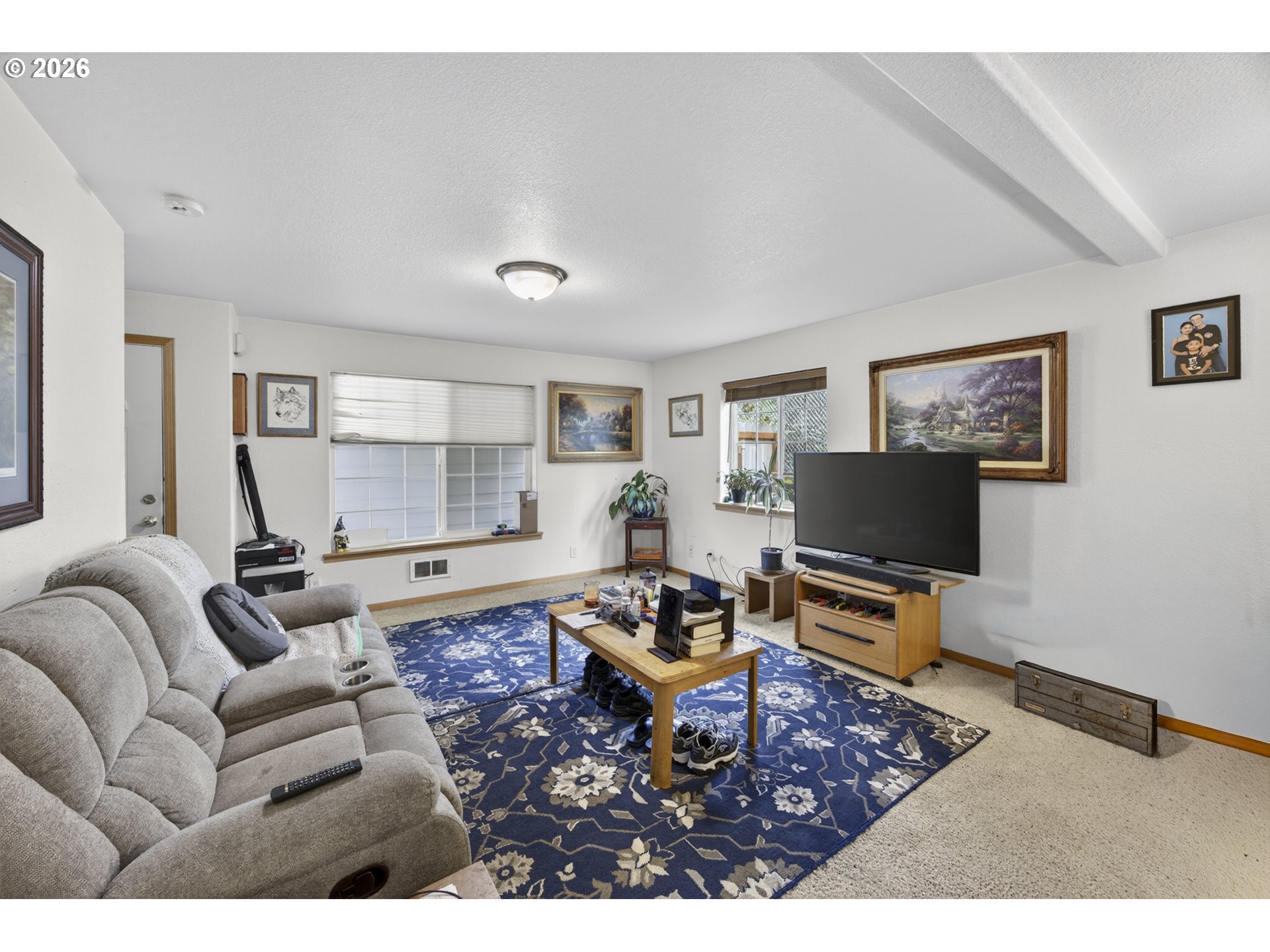 1150 Hemlock Street, Unit B8 Florence, OR 97439 - Photo 3 of 24 a living room with furniture and a flat screen tv